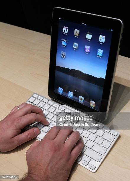 An event guest plays with the new Apple iPad that is docked in a keyboard during an Apple Special Event at Yerba Buena Center for the Arts January...