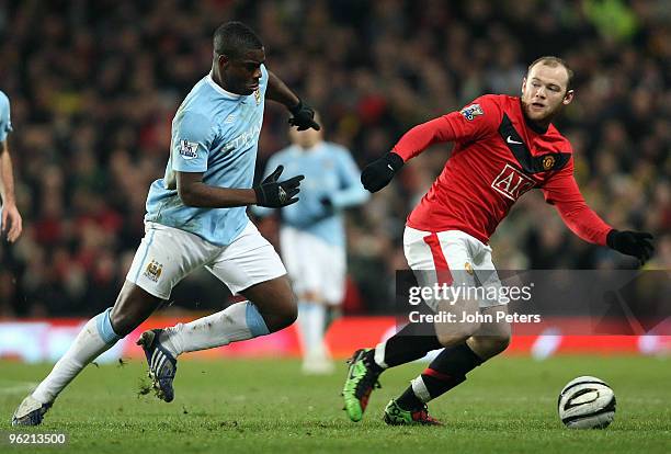 Wayne Rooney of Manchester United clashes with Micah Richards of Manchester City during the Carling Cup Semi-Final Second Leg match between...