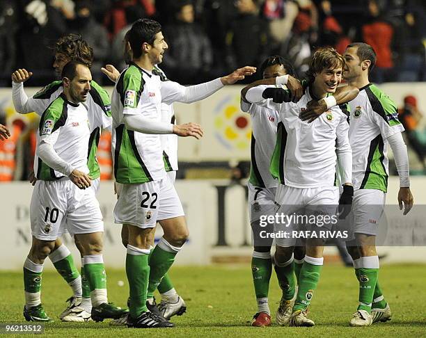 Racing's Sergio Canales celebrates with teammates after scoring his team's third goal against Osasuna during the Spanish King's Cup quarter final...