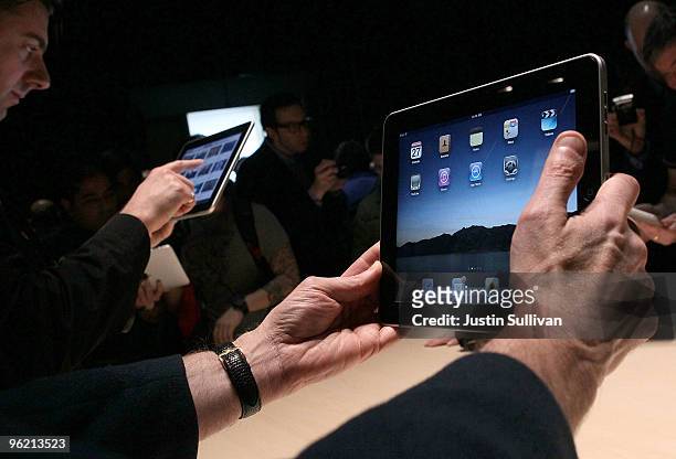 Event guests play with the new Apple iPad during an Apple Special Event at Yerba Buena Center for the Arts January 27, 2010 in San Francisco,...