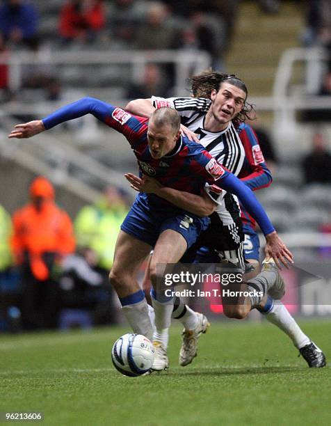 Andy Carroll hangs on to Clint Hill during the Coca-Cola championship match between Newcastle United and Crystal Palace at St James' Park on January...