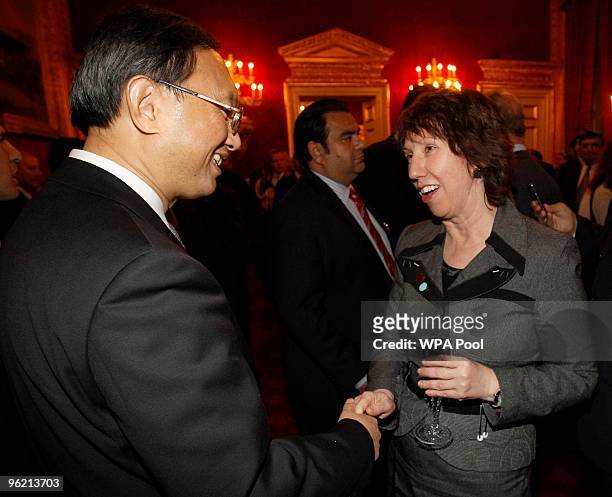 China's Foreign Minister Yang Jiechi greets European Union High Representative for Foreign Affairs Catherine Ashton during a reception for the...