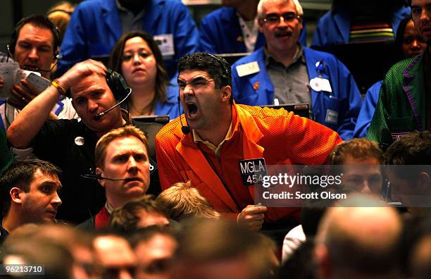 Pete Kosanovich yells an offer in the Eurodollar pit at the CME Group following the announcement from the Federal Open Market Committee that it would...