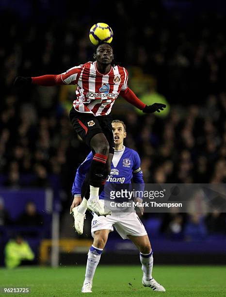 Phil Neville of Everton tangles with Kenwyne Jones of Sunderland during the Barclays Premier League match between Everton and Sunderland at Goodison...