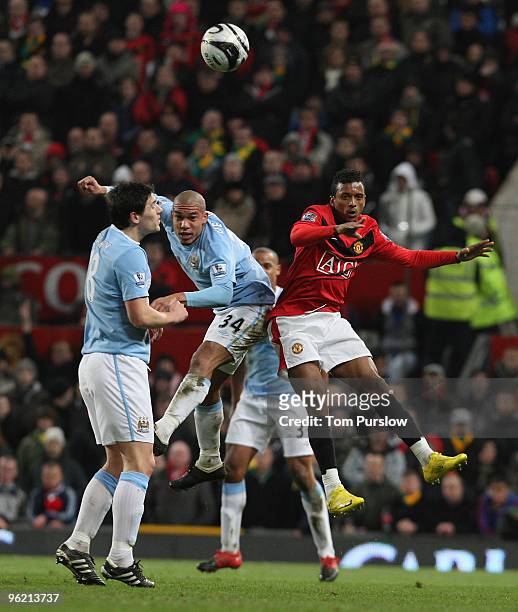 Nani of Manchester United clashes with Nigel De Jong of Manchester City during the Carling Cup Semi-Final Second Leg match between Manchester United...