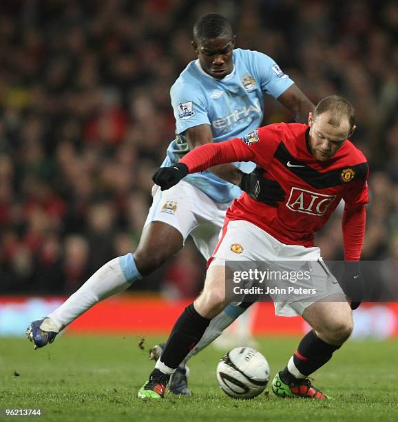 Wayne Rooney of Manchester United clashes with Micah Richards of Manchester City during the Carling Cup Semi-Final Second Leg match between...