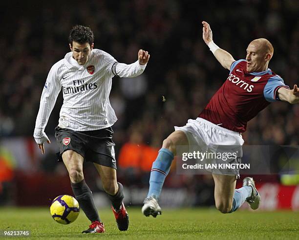 Arsenal's Spanish midfielder Cesc Fabregas vies with Aston Villa's Welsh defender James Collins during the English Premier League football match...