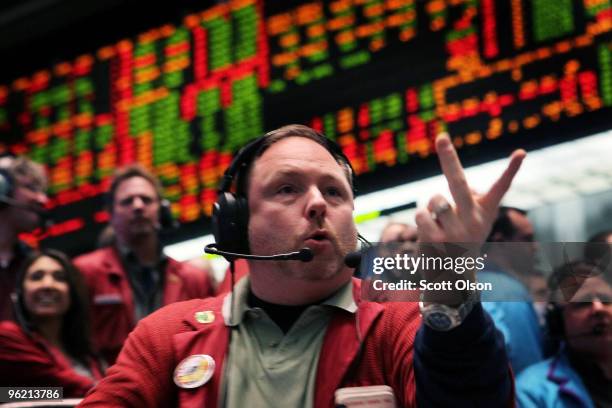 Sean Ridgeway signals an offer in the Eurodollar pit at the Chicago Mercantile Exchange following the announcement from the Federal Open Market...