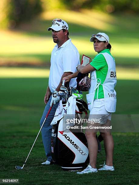 Kris Blanks looks over a shot with caddie A.J. Eathorne during the first round of the Sony Open at Waialae Country Club on January 14, 2010 in...