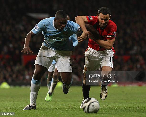 Ryan Giggs of Manchester United clashes with Micah Richards of Manchester City during the Carling Cup Semi-Final Second Leg match between Manchester...