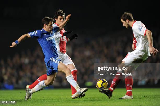 Joe Cole of Chelsea is challenged by Roger Johnson of Birmingham City during the Barclays Premier League match between Chelsea and Birmingham City at...