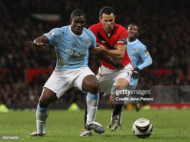 Ryan Giggs of Manchester United clashes with Micah Richards of Manchester City during the Carling Cup Semi-Final Second Leg match between Manchester...