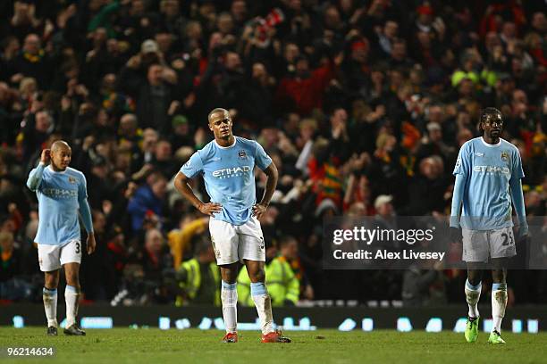 Vincent Kompany of Manchester City and his team mates show their dejection during the Carling Cup Semi Final second leg match between Manchester...