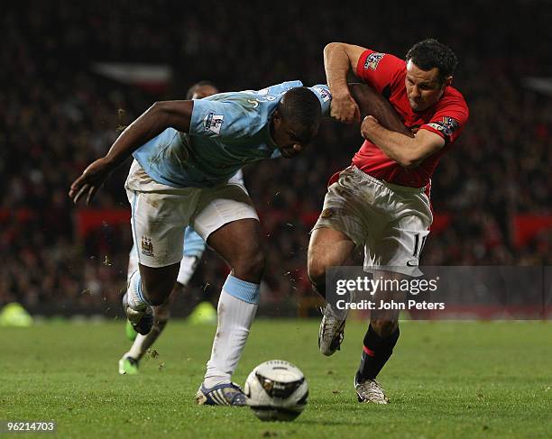 Ryan Giggs of Manchester United clashes with Micah Richards of Manchester City during the Carling Cup Semi-Final Second Leg match between Manchester...
