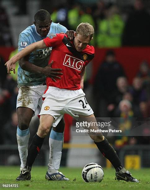 Darren Fletcher of Manchester United clashes with Micah Richards of Manchester City during the Carling Cup Semi-Final Second Leg match between...