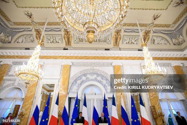 Russian President Vladimir Putin and his French counterpart Emmanuel Macron give a joint press conference following their talks at the Konstantin...