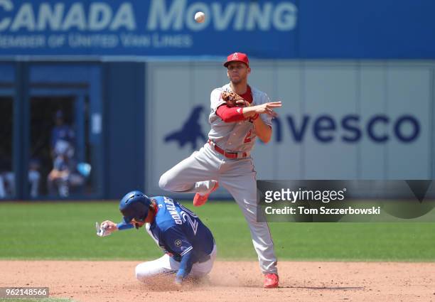Andrelton Simmons of the Los Angeles Angels of Anaheim turns a double play in the sixth inning during MLB game action as Josh Donaldson of the...