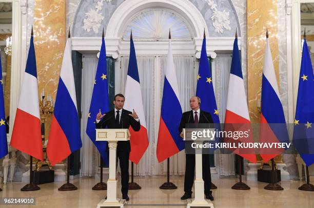 Russian President Vladimir Putin and his French counterpart Emmanuel Macron give a joint press conference following their talks at the Konstantin...