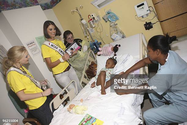 Miss USA Kristen Dalton and Miss Universe Stefania Fernandez greats a Haiti eathquake victim duuring Project Sunshine's "Star For A Day" program at...