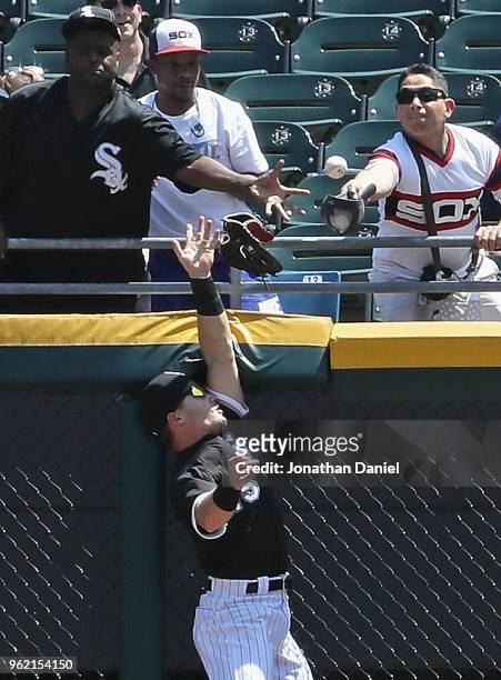 Adam Engel of the Chicago White Sox looses his glove over the fence trying to catch a home run ball hit by Adam Jones of the Baltimore Orioles in the...