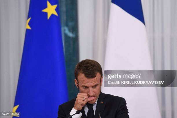 French President Emmanuel Macron attends a joint press conference with his Russian counterpart following their talks at the Konstantin Palace in...