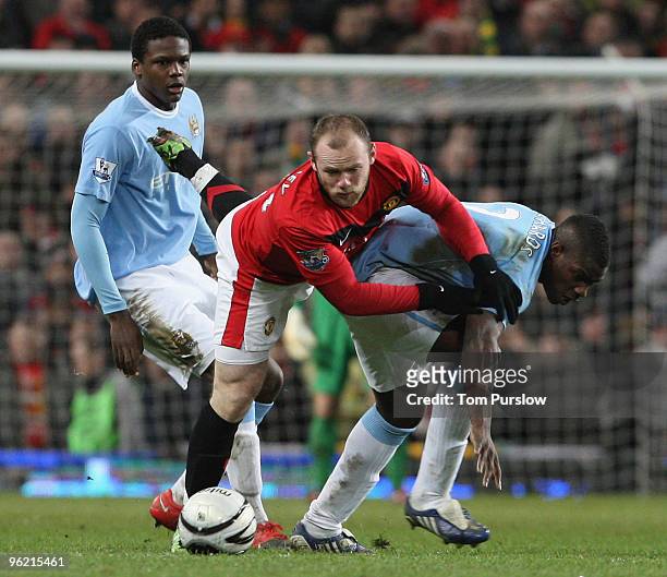 Wayne Rooney of Manchester United clashes with Micah Richards of Manchester City during the Carling Cup Semi-Final Second Leg match between...