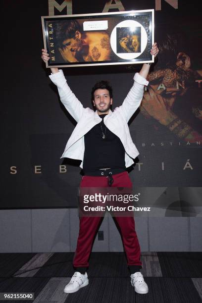 Colombian singer Sebastian Yatra receives a platinum disc for more than 60,000 copies sold of his album "Mantra" at Universal Music on May 24, 2018...