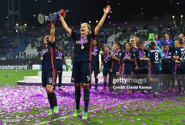 Eugenie Le Sommer and Ada Hegerberg of Lyon celebrate with the trophy during the UEFA Womens Champions League Final between VfL Wolfsburg and...