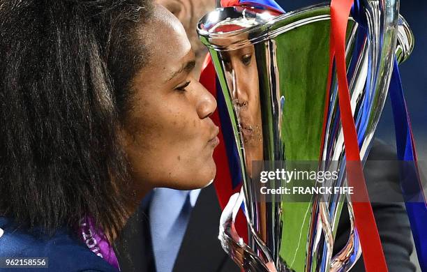 Olympique Lyonnais' French defender Wendie Renard kisses the trophy after the UEFA Women's Champions League final football match Vfl Wolfsburg vs...