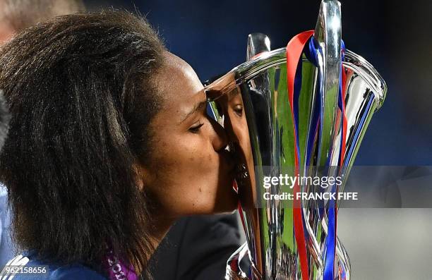 Olympique Lyonnais' French defender Wendie Renard kisses the trophy after the UEFA Women's Champions League final football match Vfl Wolfsburg vs...