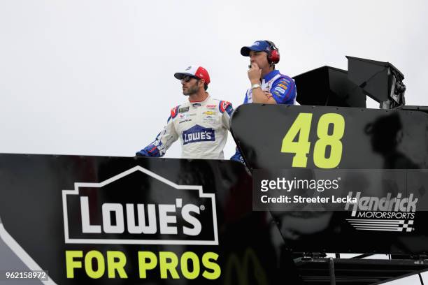 Jimmie Johnson, driver of the Lowe's Patriotic Chevrolet, and his crew chief Chad Knaus look on from the top of the team hauler during practice for...