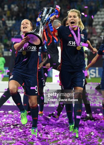 Eugenie Le Sommer and Ada Hegerberg of Lyon celebrate with the trophy during the UEFA Womens Champions League Final between VfL Wolfsburg and...