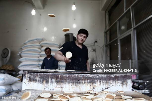 Syrian youth prepares "Qatayef", traditional pancakes that are popular during the Muslim fasting month of Ramadan, in the northern town of al-Bab on...