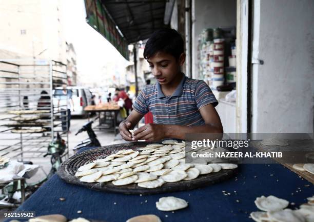 Syrian youth prepares "Qatayef", traditional pancakes that are popular during the Muslim fasting month of Ramadan, in the northern town of al-Bab on...