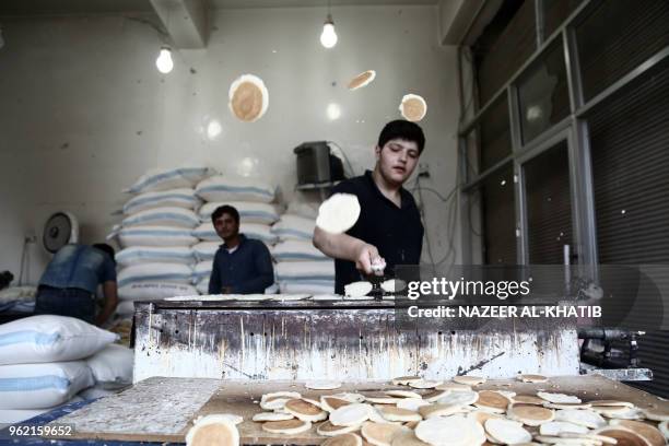 Syrian youth prepares "Qatayef", traditional pancakes that are popular during the Muslim fasting month of Ramadan, in the northern town of al-Bab on...