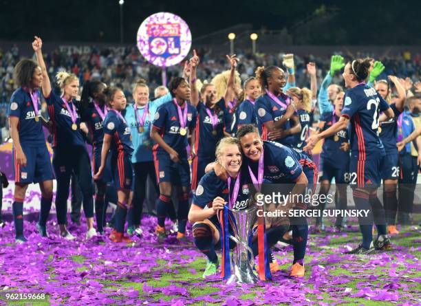 Olympique Lyonnais' Norwegian forward Ada Hegerberg and Olympique Lyonnais' Dutch forward Shanice Van De Sandern pose with the trophy as they...