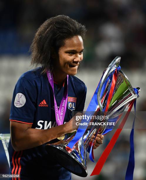 Olympique Lyonnais' French defender Wendie Renard holds the trophy as she celebrates their victory after the UEFA Women's Champions League final...