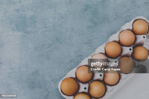 cardboard eggs package in rustic background.copyspace - dozen eggs stock pictures, royalty-free photos & images