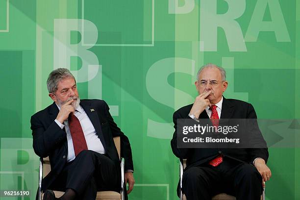 Brazilian President Luiz Inacio Lula da Silva, left, and Defense Minister Nelson Jobim listen to a question during a ceremony at the Planalto Palace...