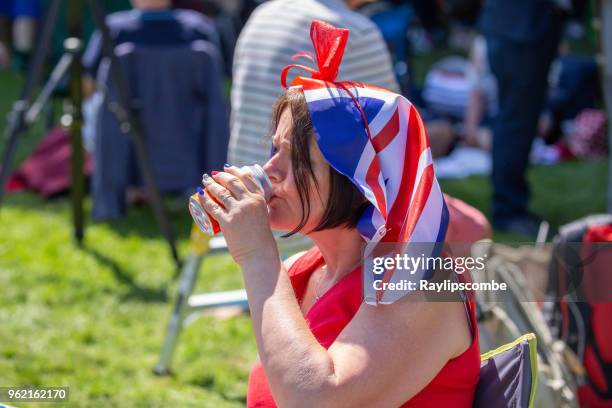 woman wearing a union jack headscarf relaxing with a drink amongst the crowds of people lining windsor great park’s ‘long walk’ to celebrate the marriage of meghan markle and prince harry - jack lord stock pictures, royalty-free photos & images