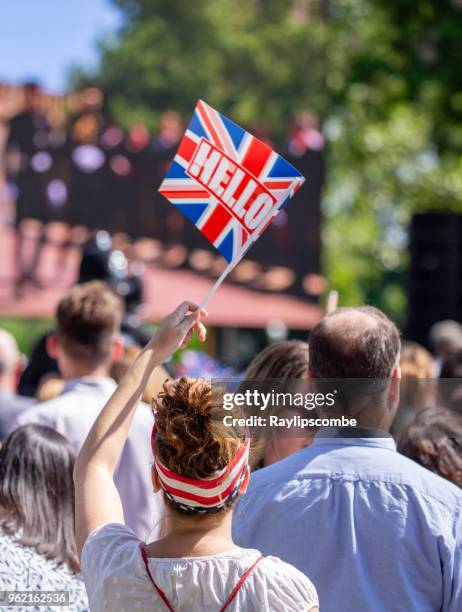 women waving a union jack flag amongst the crowds of people gathering in windsor great park to celebrate the marriage of meghan markle and prince harry - jack lord stock pictures, royalty-free photos & images