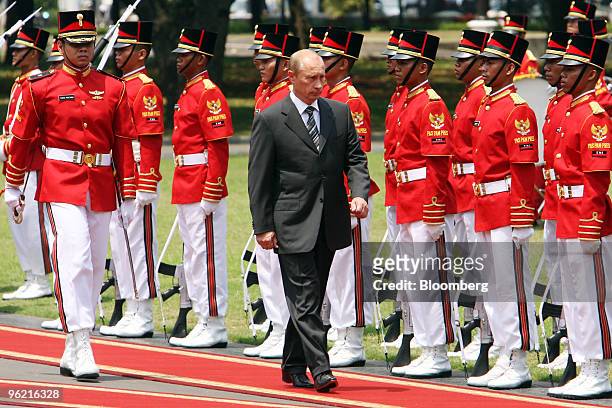 Vladimir Putin, Russia's president, inspects a line of soldiers during a welcoming ceremony at the Presidential Palace in Jakarta, Indonesia, on...