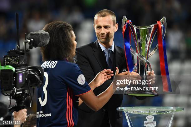 Slovenian president Aleksander Ceferin handovers Olympique Lyonnais' French defender Wendie Renard the trophy at the end of the UEFA Women's...