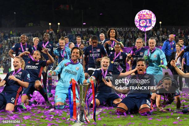 Olympique Lyonnais' players pose with the trophy as they celebrate their victory at the end of the UEFA Women's Champions League final football match...