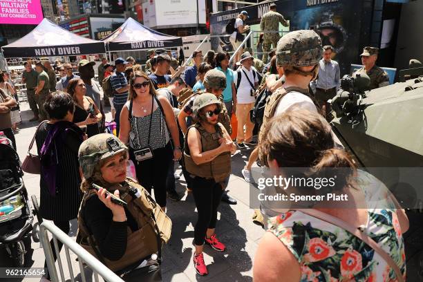 People wait in line to tour a United States Marine military vehicle in Times Square as part of Fleet Week festivities May 24, 2018 in New York City....