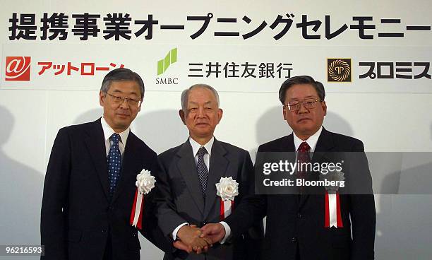 At Loan Co. President Masaaki Shimojima, left, Sumitomo Mitsui Financial Group Inc. President Yoshifumi Nishikawa, center, and Promise Co. President...