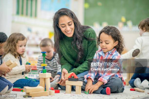 building together - baby sitter stock pictures, royalty-free photos & images