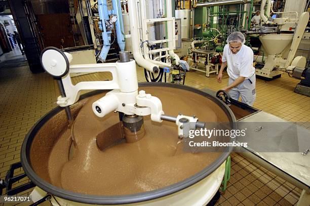 Worker checks a vat of chocolate at the Nestle plant in Broc, Switzerland, Thursday, February 19, 2004. Nestle SA, the world's largest foodmaker,...