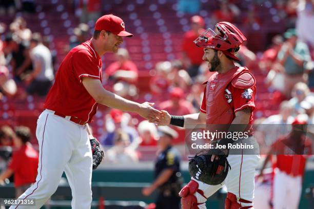 Jared Hughes and Tony Cruz of the Cincinnati Reds celebrate after the game against the Pittsburgh Pirates at Great American Ball Park on May 24, 2018...