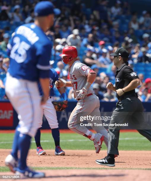 Mike Trout of the Los Angeles Angels of Anaheim circles the bases after hitting a solo home run in the fifth inning during MLB game action as Marco...